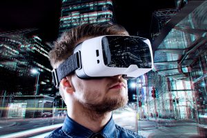Man wearing virtual reality goggles against illuminated night city